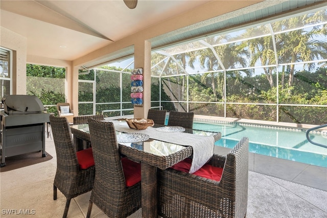 sunroom with vaulted ceiling and a pool