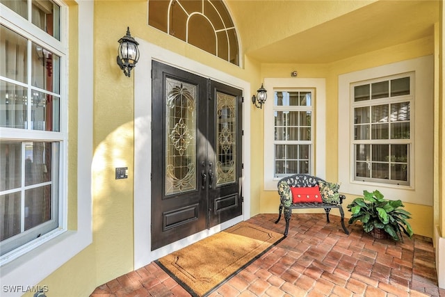 4200 Sanctuary Way, Bonita Springs, FL 34134 - property entrance with french doors, stucco siding, and covered porch