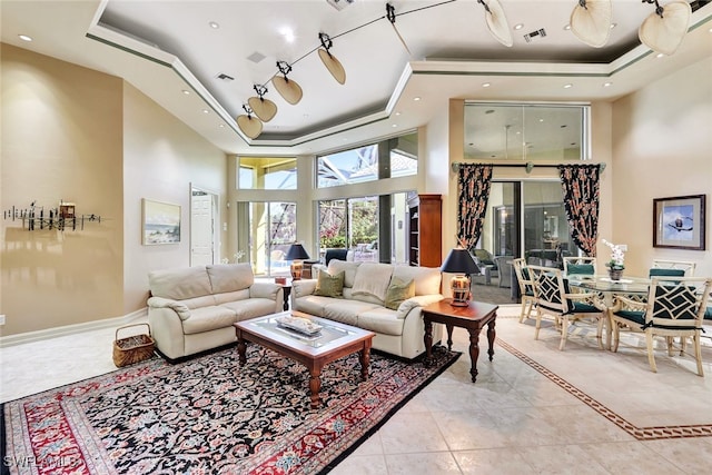 4200 Sanctuary Way, Bonita Springs, FL 34134 - living area featuring a raised ceiling, a high ceiling, and ornamental molding