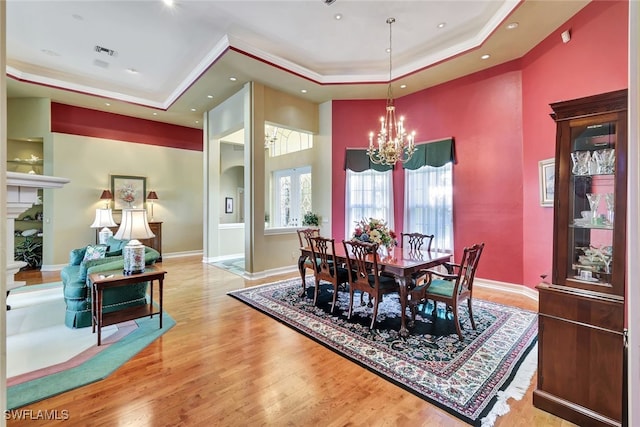 4200 Sanctuary Way, Bonita Springs, FL 34134 - dining area with a tray ceiling, a chandelier, wood finished floors, a towering ceiling, and recessed lighting