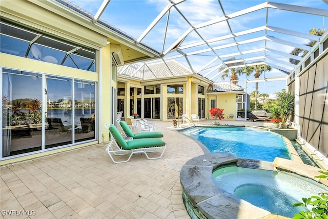 view of swimming pool featuring a lanai, an in ground hot tub, and a patio area