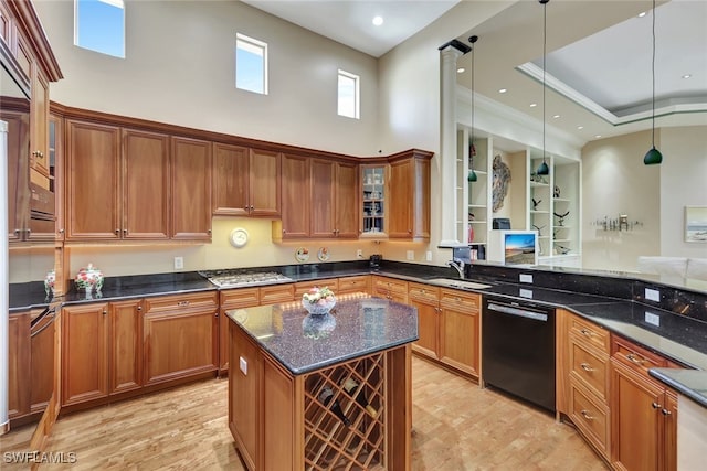 kitchen with dark stone counters, pendant lighting, a kitchen island, a high ceiling, and black dishwasher