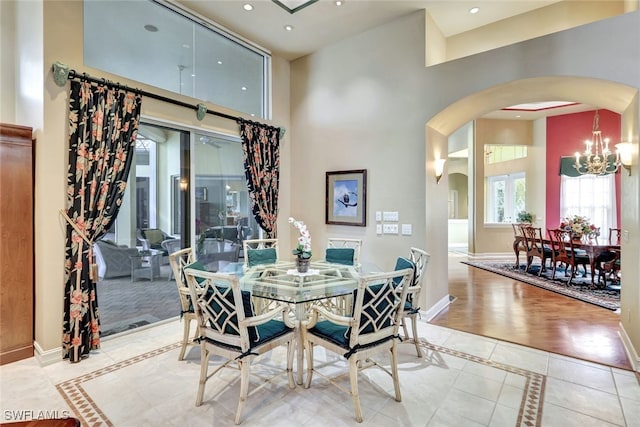 tiled dining space with a chandelier