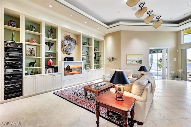 tiled living room featuring a towering ceiling and a raised ceiling