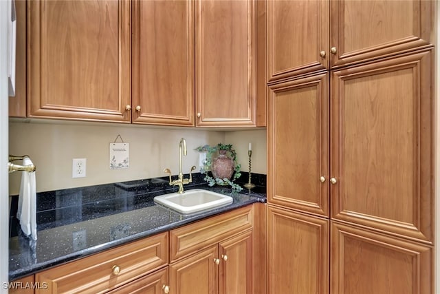 4200 Sanctuary Way, Bonita Springs, FL 34134 - kitchen with a sink and dark stone counters