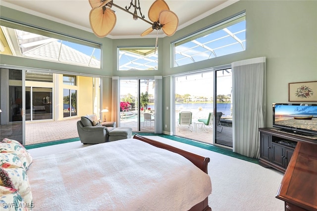 bedroom featuring a high ceiling, ornamental molding, carpet, and access to exterior