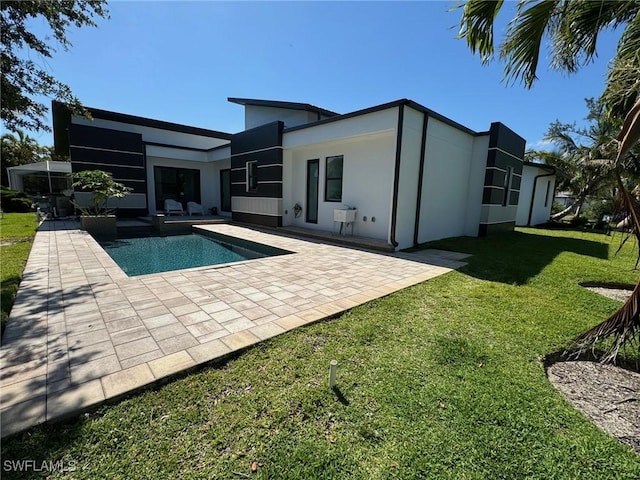 back of house featuring a patio area and a yard