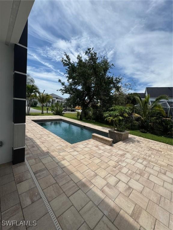 view of swimming pool with a patio area