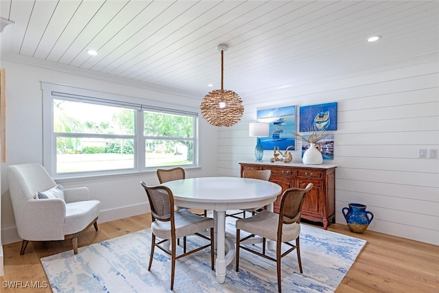 dining room with wooden ceiling and light wood-type flooring