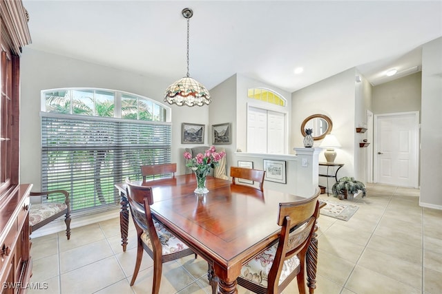 dining area featuring light tile patterned floors and lofted ceiling