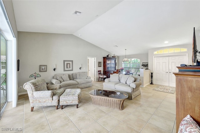 living room with light tile patterned floors and vaulted ceiling