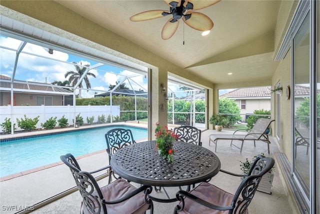 sunroom with vaulted ceiling, ceiling fan, and a healthy amount of sunlight