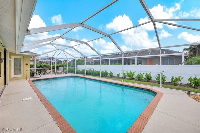 view of swimming pool with a lanai and a patio area