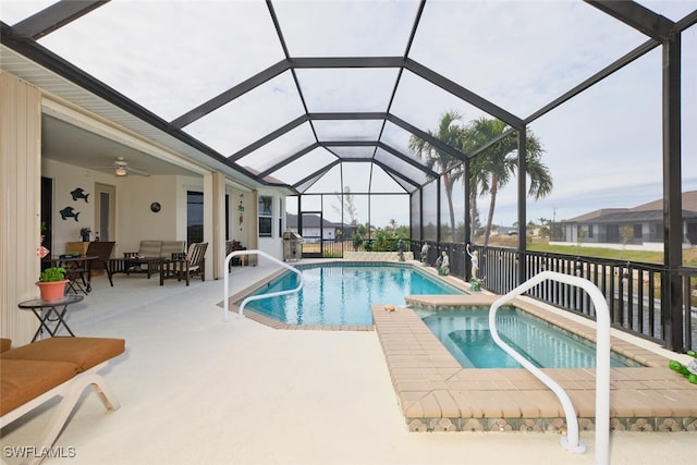 view of swimming pool featuring a lanai, ceiling fan, a hot tub, and a patio