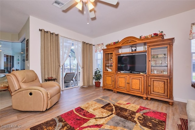 living room with ceiling fan and hardwood / wood-style floors