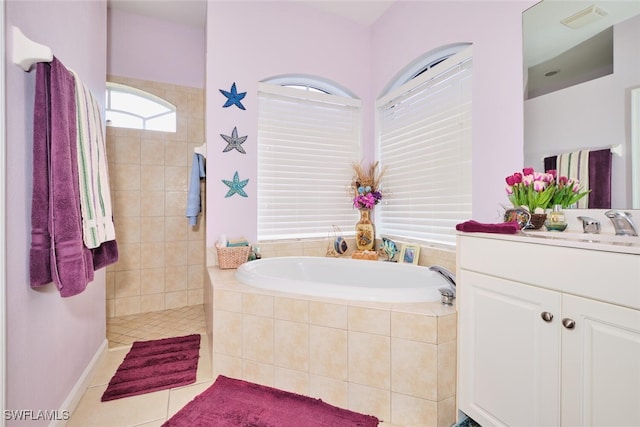 bathroom with vanity, tile patterned floors, and plus walk in shower