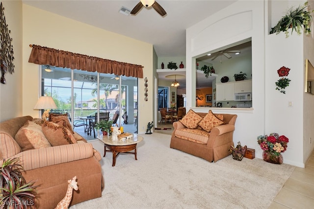 living room with ceiling fan with notable chandelier and light tile patterned flooring