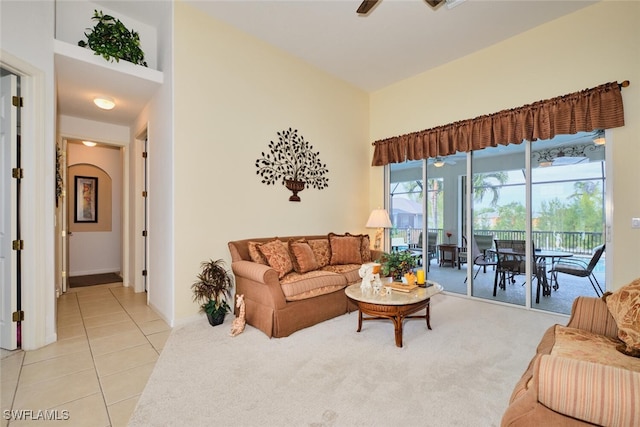 tiled living room featuring ceiling fan