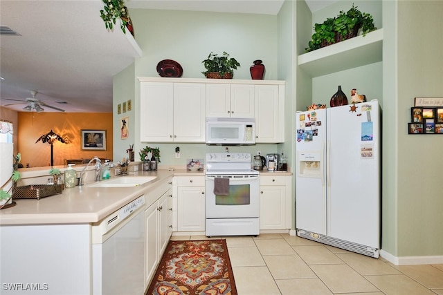 kitchen featuring light tile patterned floors, kitchen peninsula, white appliances, and white cabinetry