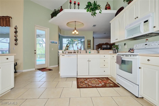 kitchen with light tile patterned floors, decorative light fixtures, white appliances, white cabinets, and sink