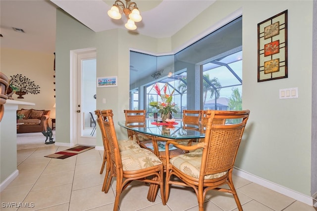 dining space with light tile patterned floors and a notable chandelier