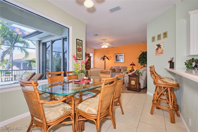 tiled dining area with ceiling fan