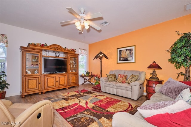 living room featuring ceiling fan and wood-type flooring