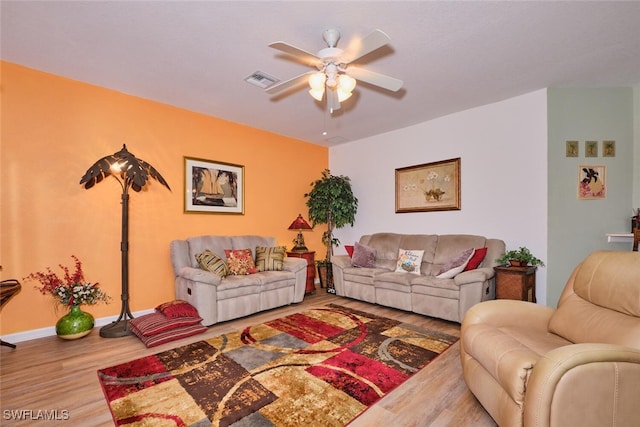 living room with ceiling fan and hardwood / wood-style flooring