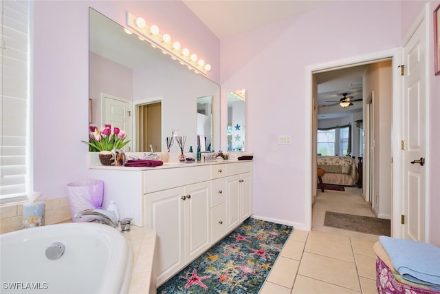 bathroom featuring tiled bath, tile patterned floors, vanity, and ceiling fan