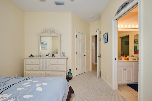 carpeted bedroom with ensuite bath