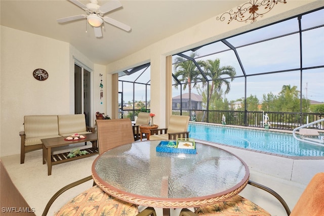 view of pool with ceiling fan and pool water feature