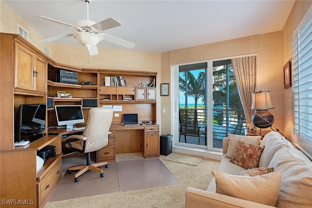 home office with light carpet and ceiling fan