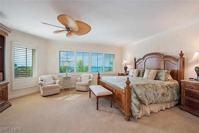 bedroom with ceiling fan, light colored carpet, and crown molding