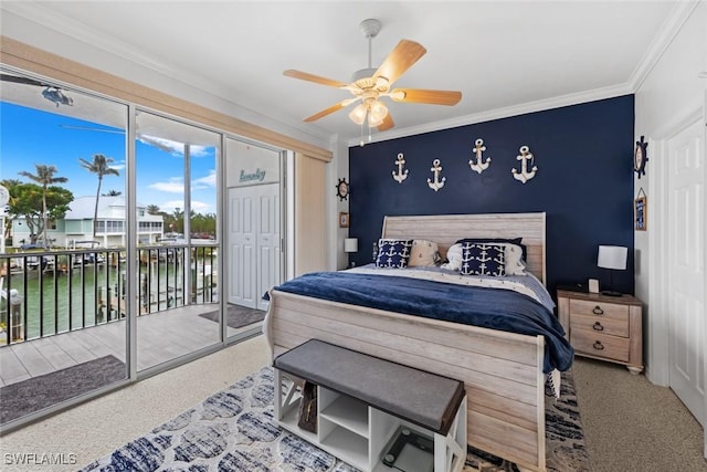 bedroom featuring a closet, crown molding, ceiling fan, access to exterior, and a water view