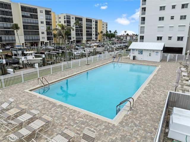 view of pool featuring a patio area and a water view