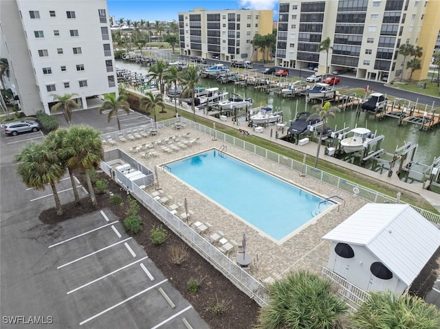 view of pool featuring a patio and a water view