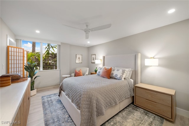 bedroom with light wood-type flooring and ceiling fan