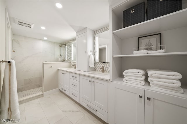 bathroom with vanity and tiled shower