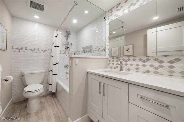 full bathroom featuring vanity, toilet, and shower / bath combo with shower curtain