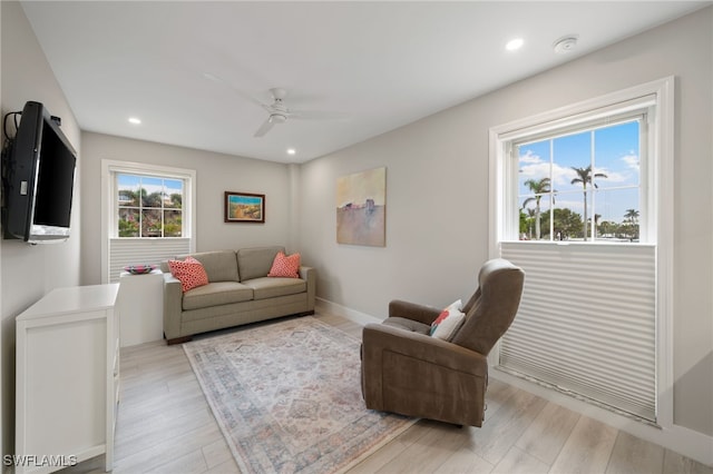 living room featuring ceiling fan and light hardwood / wood-style floors