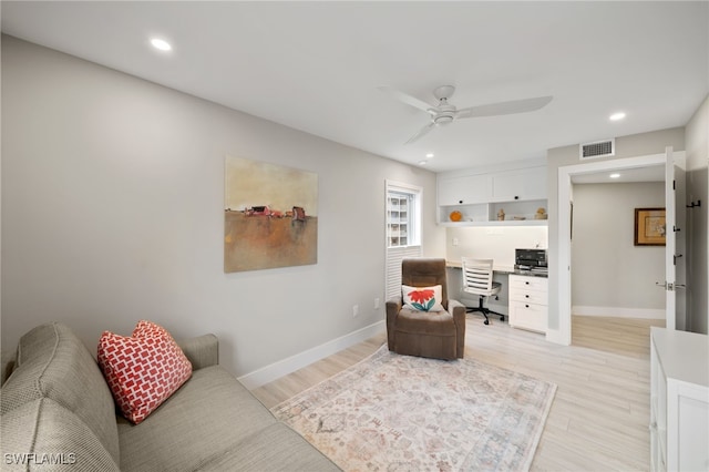 living room with ceiling fan and light wood-type flooring