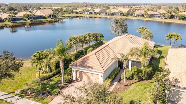 birds eye view of property with a water view