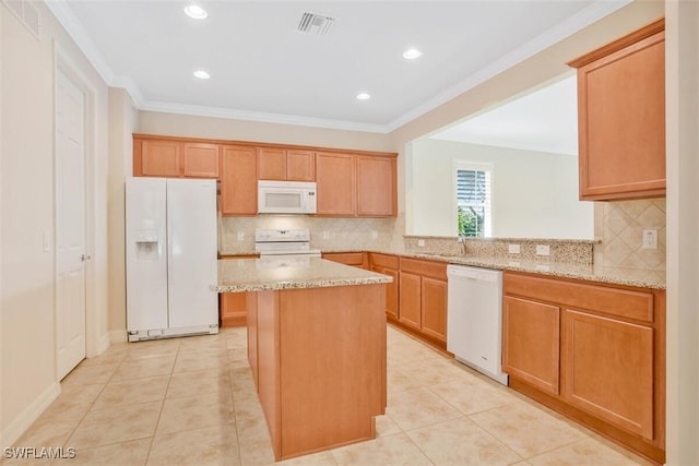 kitchen with light stone counters, light tile patterned floors, ornamental molding, kitchen peninsula, and white appliances