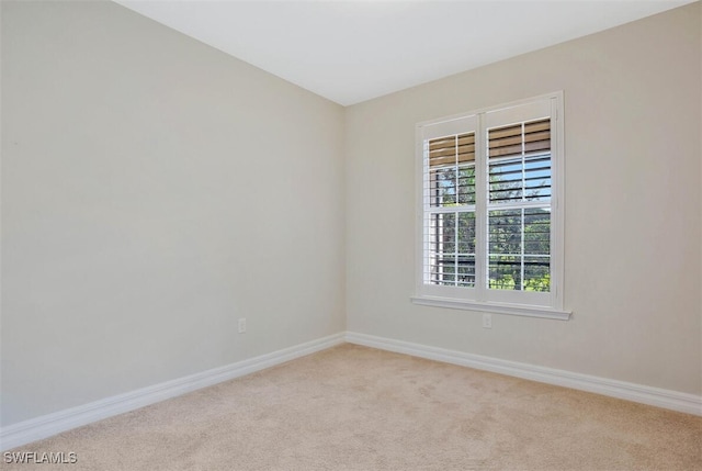 unfurnished room featuring light carpet