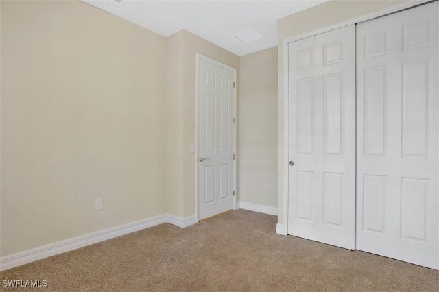 unfurnished bedroom with carpet floors and a closet