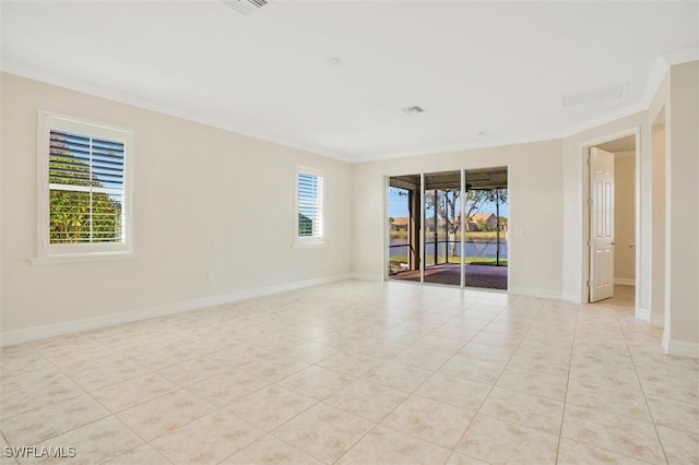 tiled spare room with crown molding and a wealth of natural light