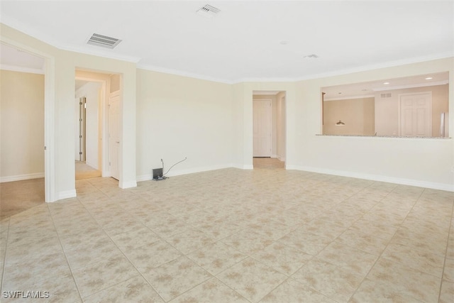 spare room with crown molding and light tile patterned floors