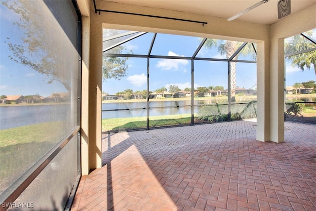 unfurnished sunroom featuring a water view