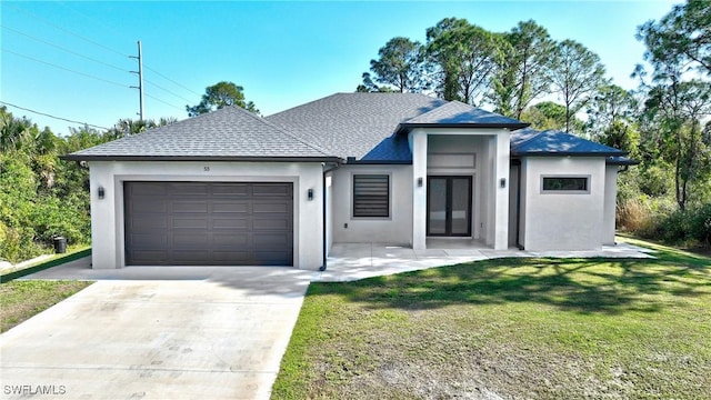 view of front of property with a front yard, a garage, and french doors