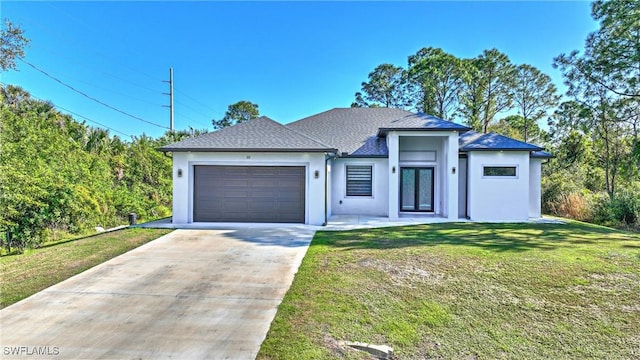 view of front of house with a garage and a front yard